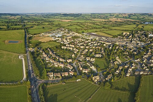 An aerial view of a village in the countryside.