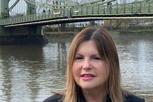 Nicola Horlick in front of Hammersmith bridge