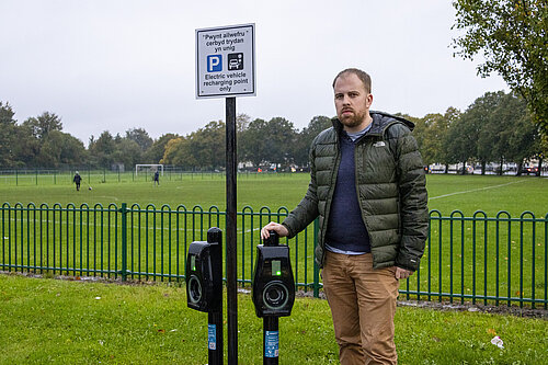 Cadan stood by an EV charger