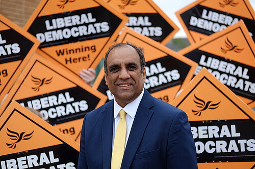 Shaffaq Mohammed in front of a sea of Lib Dem diamonds