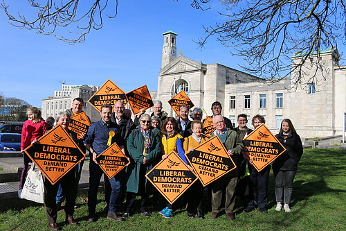 A Group of Liberal Democrats holding signs in front of Southampton Civic Cenre