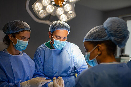 Surgeons operating in theatre