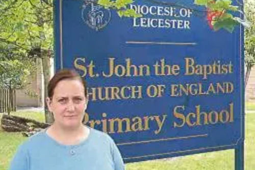 Debbie Almey outside St John the Baptist School