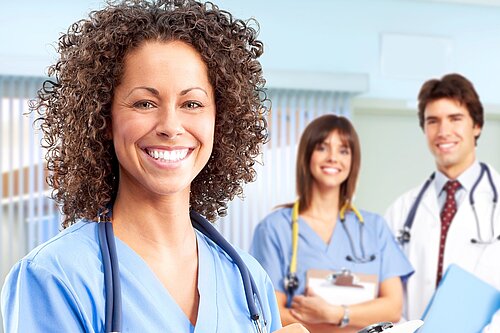 Three doctors smiling.