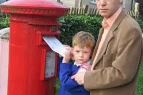 Stephen Robinson and his son post passport application