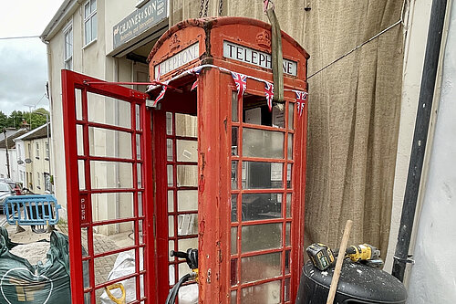 The red telephone box being removed from The Square, North Tawton