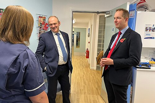 Richard Foord and Ed Davey speaking to a nurse