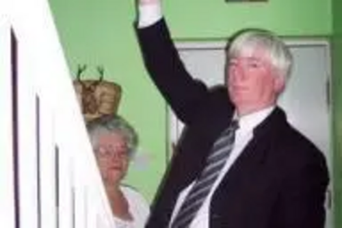 Paul fits a smoke alarm at the home of Rochdale pensioner Joyce Haynes.