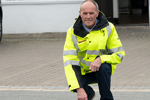 Paul in high-vis, examining the road