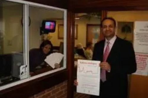 Parmjit Singh Gill MP talks to a receptionist in a doctor's surgery in Evington