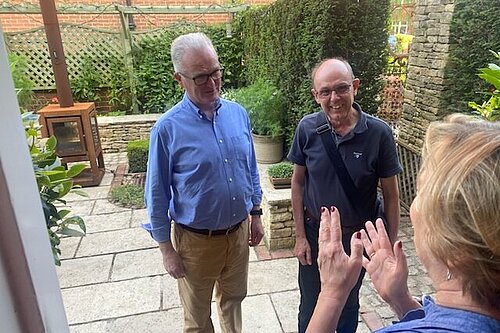 Peter Allen & Philip Browne talk to a local resident on their doorstep