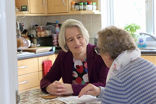 Claire young speaking to a resident