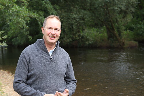 Richard Foord standing in front of a river