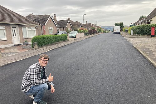 Councillor giving a resurfaced road a thumbs up