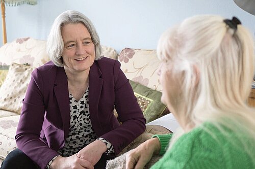 Claire Young speaking to a resident about their concerns